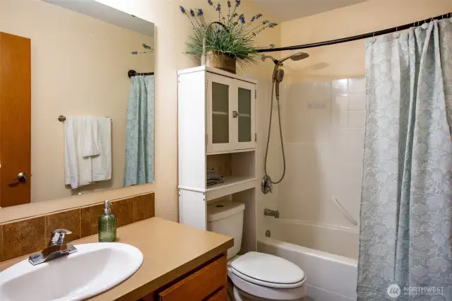 The main bath is easily accessible for guests and occupants of the the 2 bedrooms on this end of the house. This bathroom has linen storage as well.