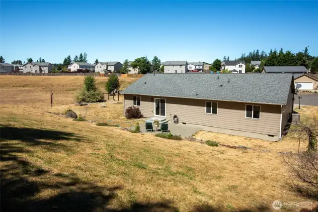From this angle atop the backyard hillside you can see the adjoining wide open space.
