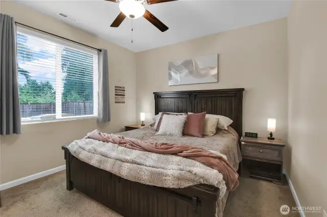 Primary bedroom with ceiling fan.