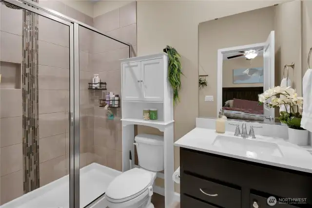 Primary bath with tile details in the glass door shower.