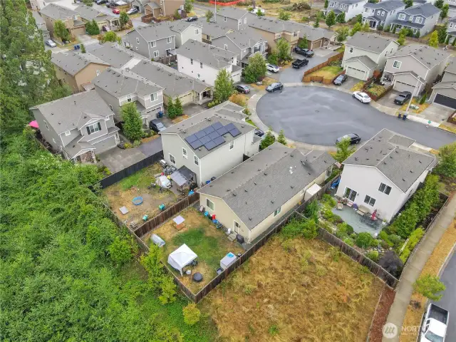 Notice how the house has greenbelt and grass on two sides