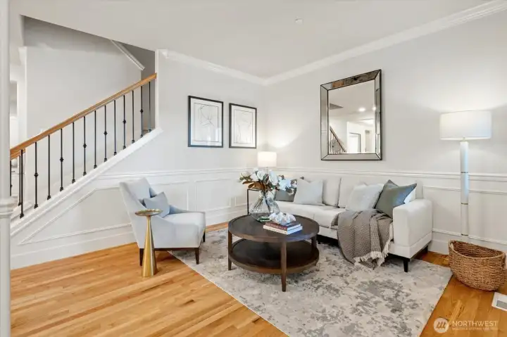 As you enter, gorgeous hardwoods greet you throughout the main level. A nice formal living room with wainscotting and other detailing.