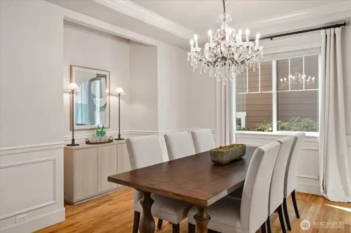 Luxurious formal dining room with architectural detailing and a Restoration Hardware chandelier!
