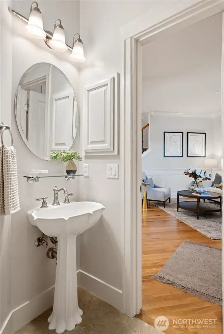 Main-level bathroom with shower offers stunning sink details that bring a touch of luxury to this home.