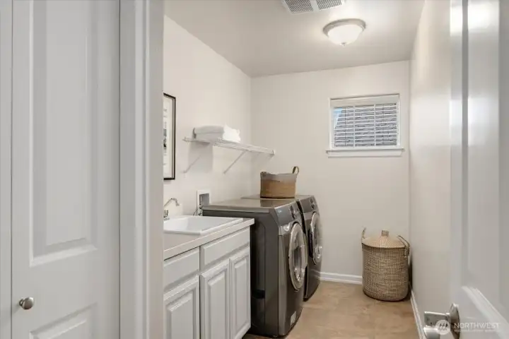 Upstairs Utility Room with linen closet and utility sink makes doing laundry easy & efficient.