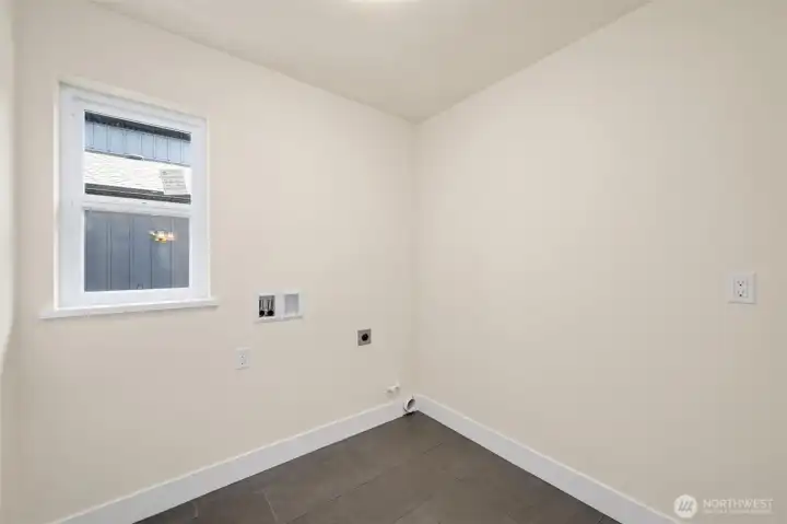 Upstairs is a separate laundry room, ready for a new washer and dryer.