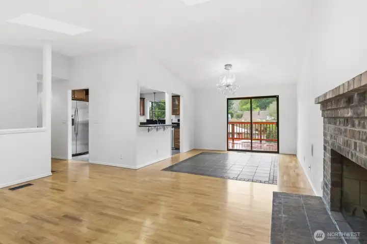 Full view from the living room, dining, and kitchen reveals a spacious, open layout ready to be customized to your style.