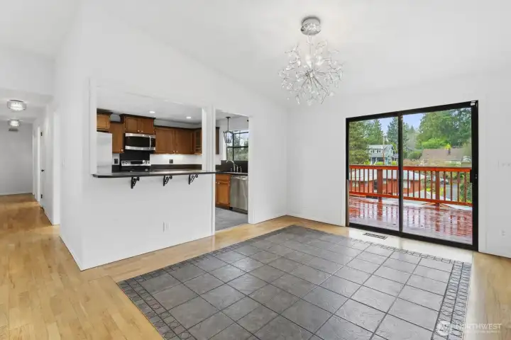 Enjoy a large dining room with a charming glass chandelier, flowing into an open kitchen with bar space for gatherings.