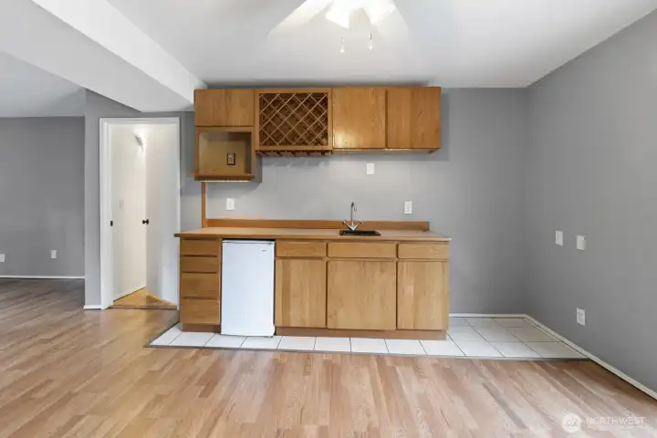Closer view of the wet bar area, complete with mini refrigerator & wine cabinet.