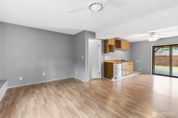 Spacious lower-level family room with ceiling fan, wet bar, wine cabinet, and patio access—perfect for entertaining or family time.