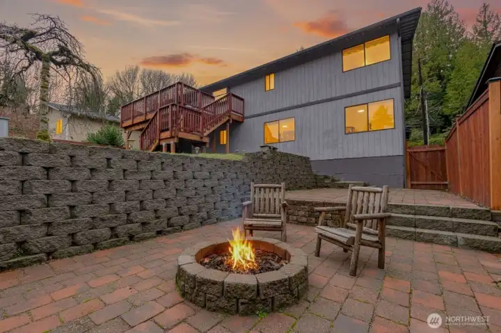 Backyard showing the elaborate Segmental Concrete Block Retaining Wall-  Virtually staged. Furniture and décor shown are for illustrative purposes only.