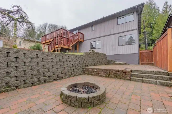 Brick patio with firepit, ideal for entertaining.    Photos have been virtually staged. Furniture and décor shown are for illustrative purposes only.
