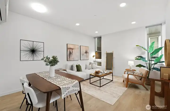 Wide plank laminate flooring anchors the space.