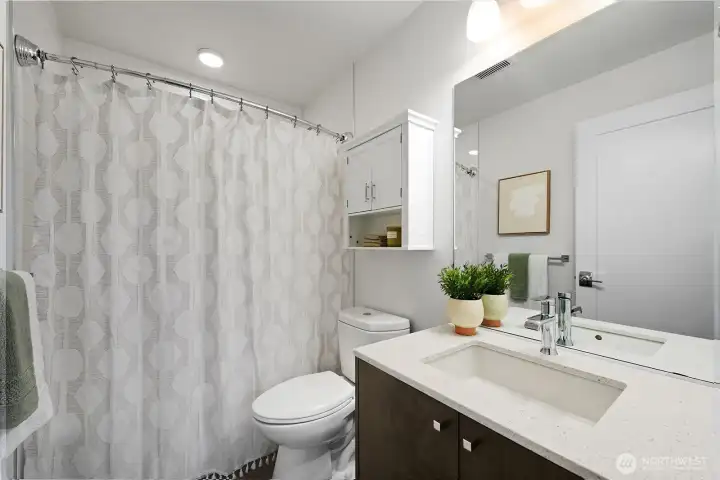 A full bath is right outside the second bedroom.