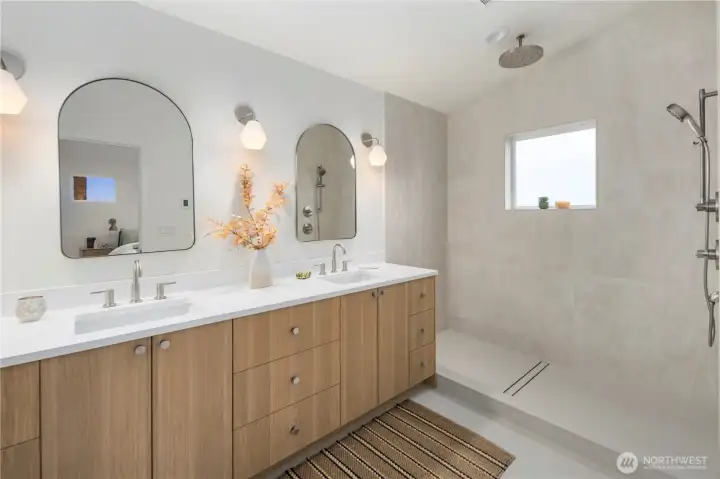 Primary bath with double vanity and plenty of cabinet storage.