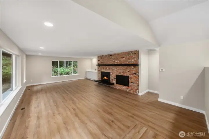 Upon entry, this huge living room is to your left. Gorgeous brick surrounded gas fireplace and built in beverage counter finish the space. The doorway to the right of the fireplace is the primary suite entrance.