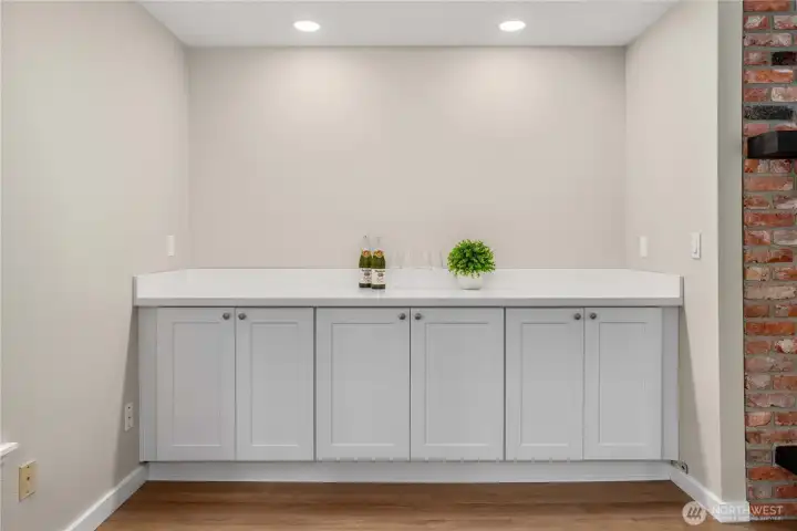 Quartz on cabinets in the corner of the living room makes a great place to store your favorite beverages.