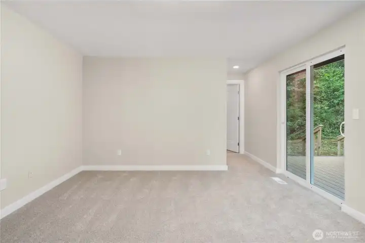 Showing the slider to the deck - perfect spot for a hot tub! - and the doorway to the bathroom beyond. The walk-in-closet runs the length of the wall straight ahead.