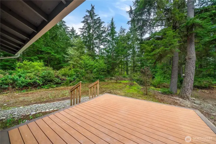 Low-maintenance composite decking off the primary suite offers room for a hot tub. With 2.28 acres, you can't see a neighbor from anywhere on the property!