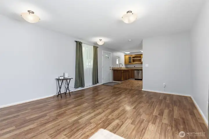 Living room facing front door and kitchen