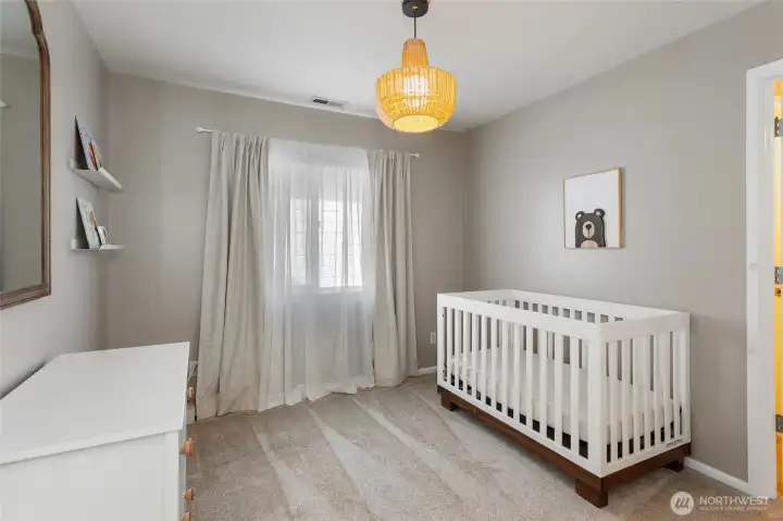 Well-appointed secondary bedroom filled with natural light and neutral finishes. This bedroom shares a Jack-and-Jill bathroom with the adjacent bedroom, providing convenient access while maintaining privacy for both rooms—an ideal layout