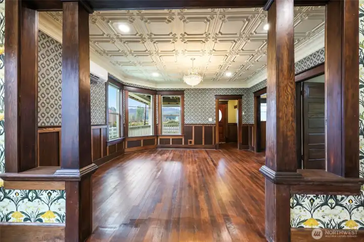 View from dining room into living room.  Notice restored historic mill work.