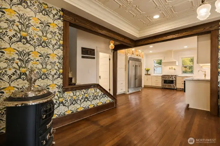 From dining room, stairs to upstairs on left, main floor bath.