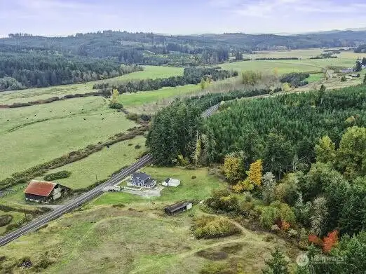 Arial view of much of homestead.  Notice no neighbors nearby.  Back of your land is forested and backs up to Port Blakely forest, so you will not have neighbors behind you- land across road is grazing land that is not suitable for building, so you will have a very private property long term.