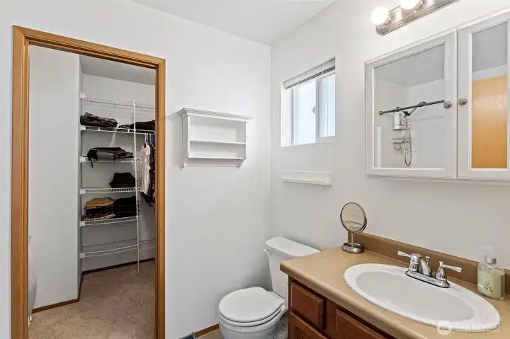Primary Bath with walk-in closet with  tub/shower to the left.