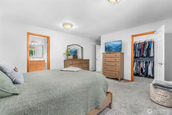 Primary bedroom view toward large walk-in closet and ensuite bathroom
