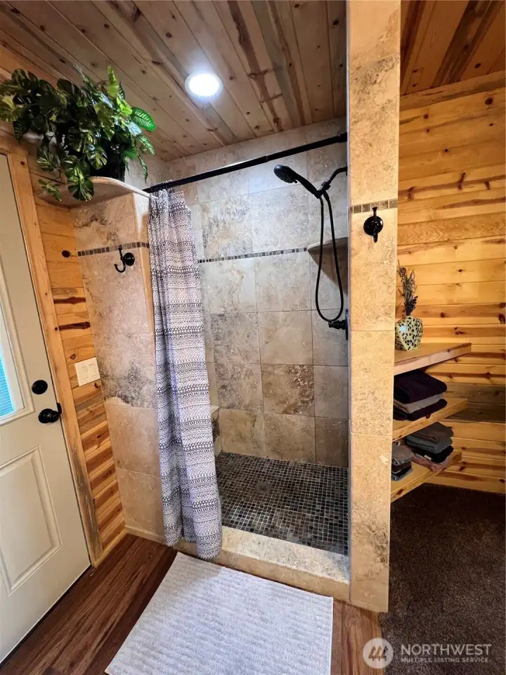 Walk in shower with travertine tile