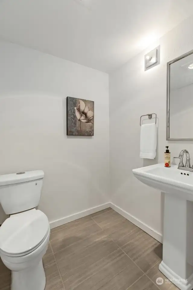 Main floor has a large 1/2 bath with new tile flooring. All toilets & sinks are also new!