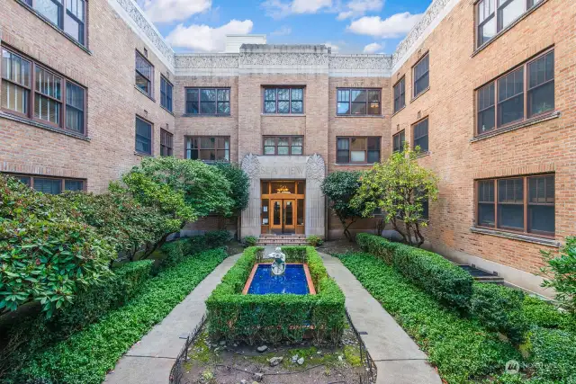 Gorgeous Art Deco style building, Seaview Condominium, was originally built in 1930 and retains the architectural integrity of the era. Formal gardens flank the fountain and pool leading to the entry. The view from #401 is of this courtyard.