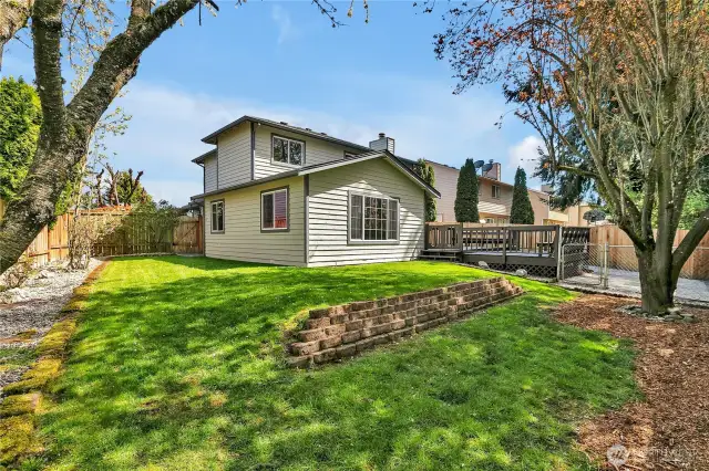 The backyard has a newly built fence and the landscaping has been spruced up.