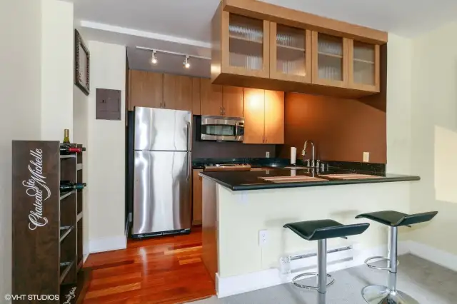 Stainless steel appliances and bar seating.