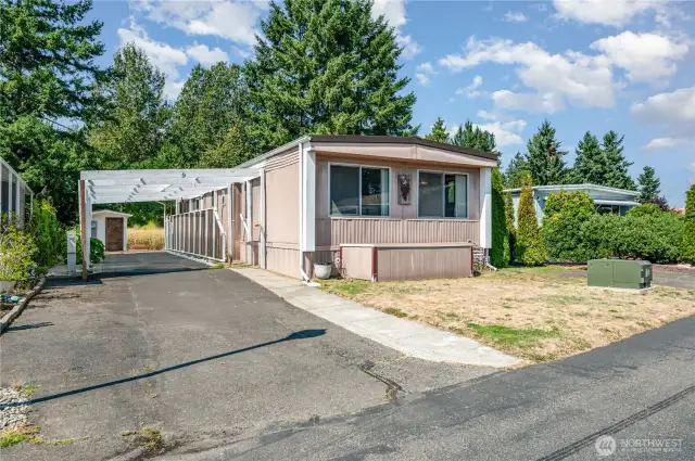 Carport fits one car with room in the driveway for another car!