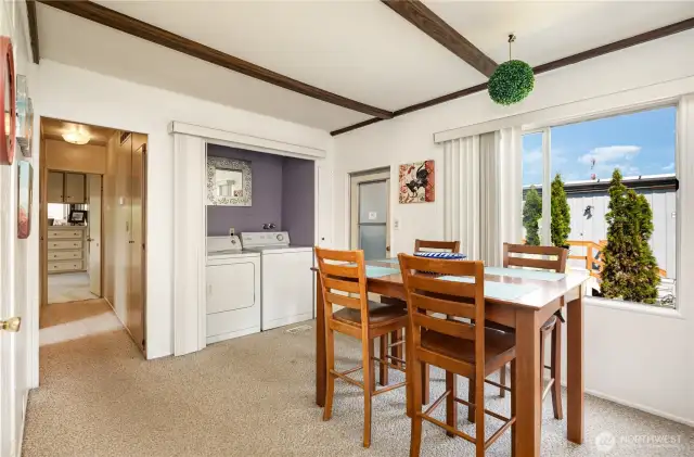 Another view of the dining area, hallway leads to the bedrooms.