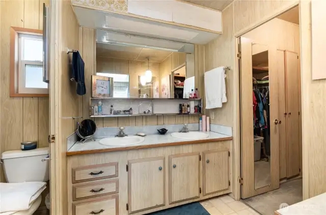 Primary bathroom with dual sinks and separate water closet.