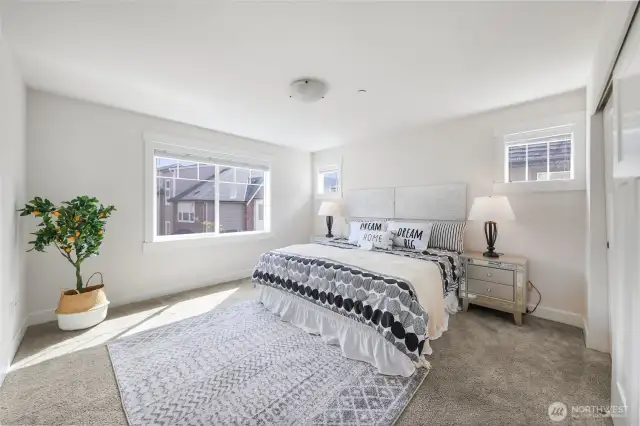 Spacious primary suite on upper level with ensuite bath, a regular closet and another walk-in closet.