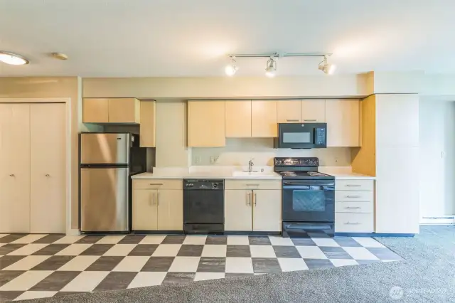 This open-concept studio offers a full kitchen with contemporary cabinetry—ideal for modern urban living.