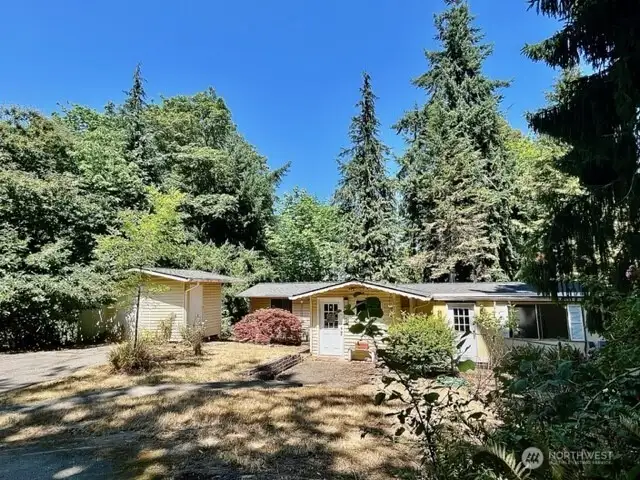 The vintage cottage on it's 1+ acre high bank waterfront lot