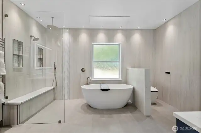 Newly renovated primary bathroom with matching Grohe fixtures, heated porcelain tile floor, under cabinet lights with motion sensors, and a bidet toilet