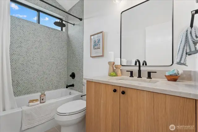 Upstairs hallway bathroom.  Gorgeous penny-mosaic shower and custom vanity.