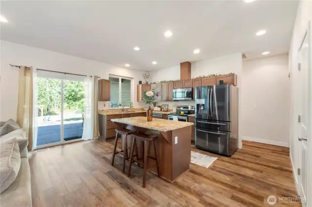 Kitchen has stainless steel appliances (all stay) and granite countertops.