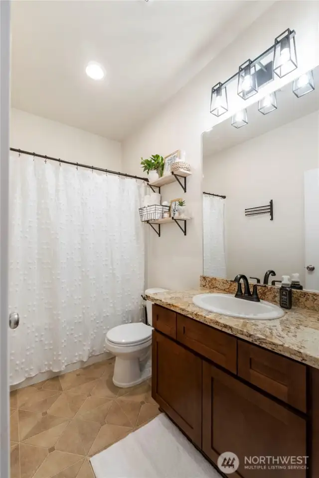 Guest Bathroom with tub/shower combo. Granite countertops.