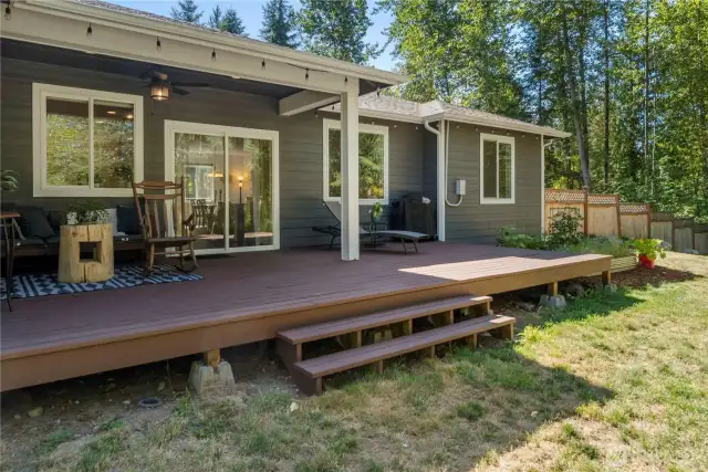 Covered patio allows you to enjoy the outdoors, rain or shine! Garden beds to the right of the porch, too.