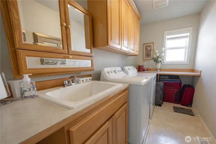 Upstairs Utility Room, featuring sink, and lots of cabinet space.