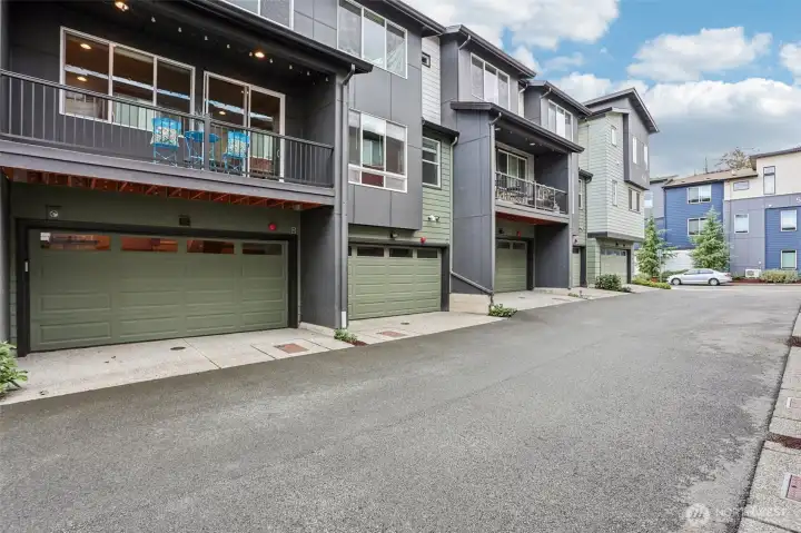 Rear exterior with 2-car garage and private balcony