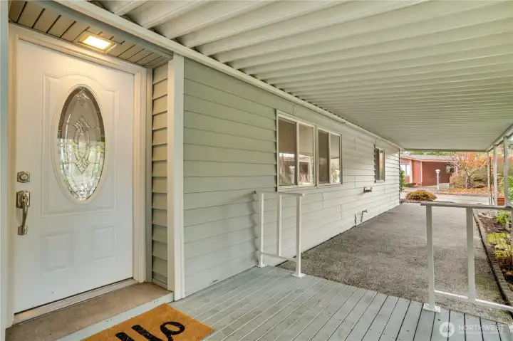 A large covered front porch keeps you dry on those rainy Pacific Northwest days—notice the freshly painted trim and porch railing for a crisp, updated look.