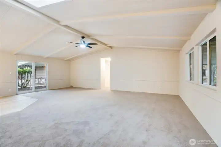 To the other side of the entry, discover a spacious living room with vaulted ceilings and fresh paint throughout—warm and welcoming from the moment you arrive.